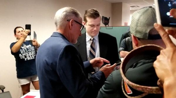 Screenshot from video showing legislative aide to Florida Rep. Chuck Brannan being handed a framed Oath Breakers Hall of Shame certificate by Republican Liberty Caucus leader Bob White. 