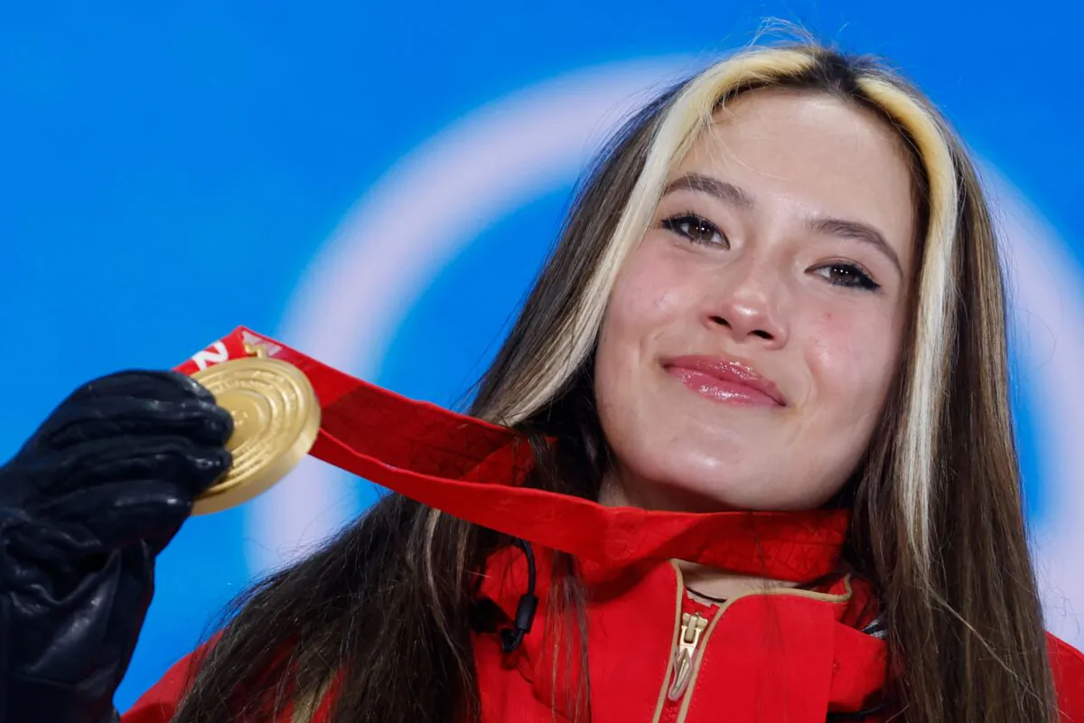 Gold medallist China's Eileen Gu poses on the podium during the freestyle skiing women's freeski halfpipe victory ceremony of the 2022 Beijing Winter Olympic Games at the Zhangjiakou Medals Plaza in Zhangjiakou, China, on Feb. 18, 2022. (Odd Andersen/AFP via Getty Images)