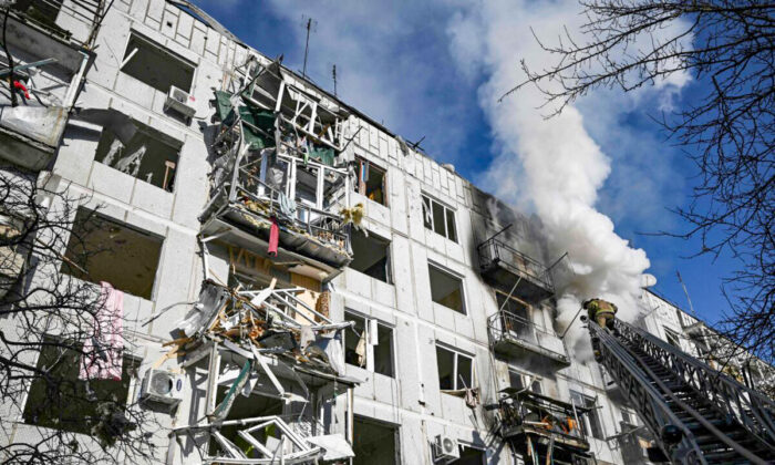 Firefighters work on a fire on a building after bombings on the eastern Ukraine town of Chuguiv on Feb. 24, 2022. (Aris Messinis/AFP via Getty Images)