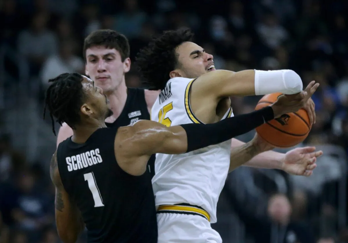 Providence Friar Justin Minaya struggles to keep the ball from Xavier defenders Paul Scruggs and Zach Freemantle against a Musketeer press. (Kris Craig/USA TODAY NETWORK via Field Level Media)