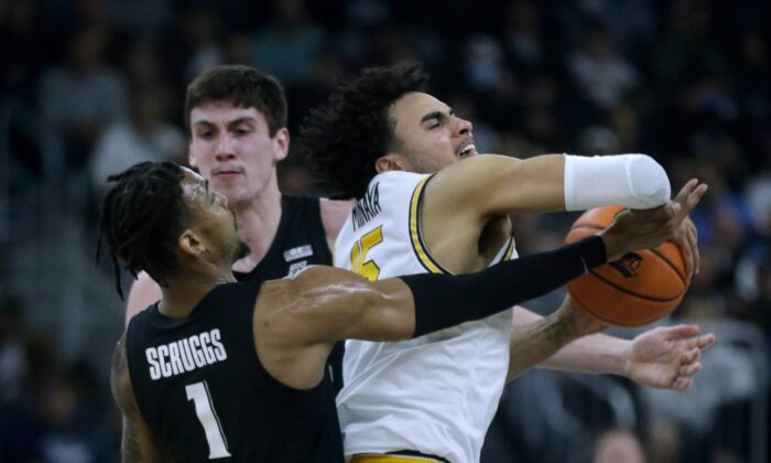 Providence Friar Justin Minaya struggles to keep the ball from Xavier defenders Paul Scruggs and Zach Freemantle against a Musketeer press. (Kris Craig/USA TODAY NETWORK via Field Level Media)