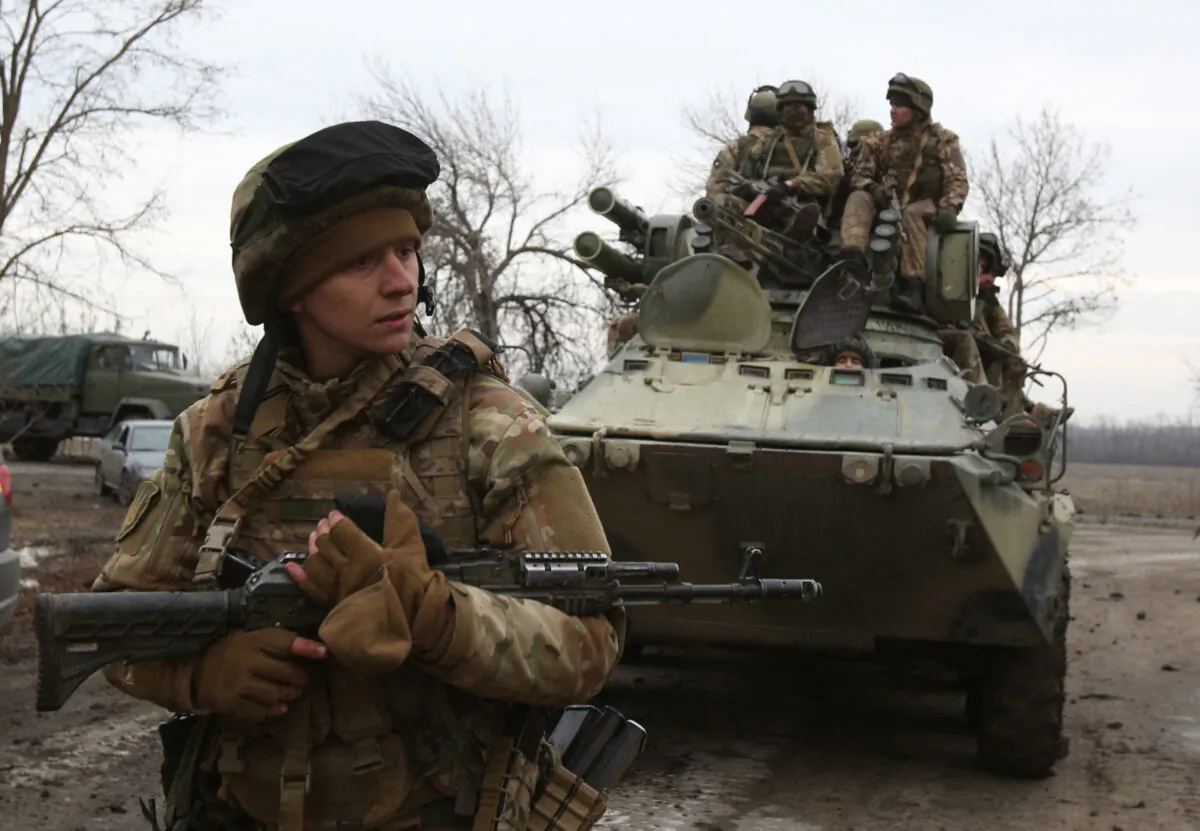 Ukrainian servicemen get ready to repel an attack in Ukraine's Lugansk region on Feb. 24, 2022. (Anatolii Stepanov/AFP via Getty Images)