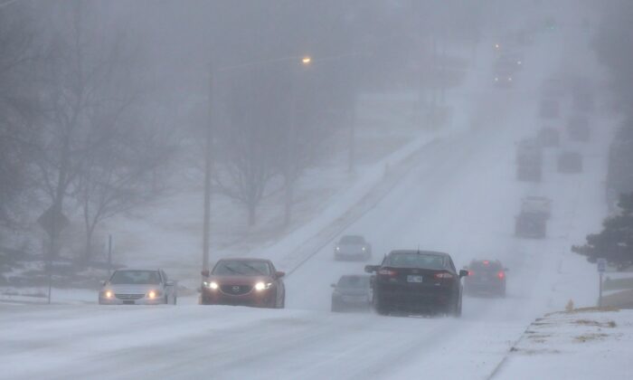 Motorists drive during a sleet storm in Tulsa, Okla., on Feb. 23, 2022. (Stephen Pingry/Tulsa World via AP)