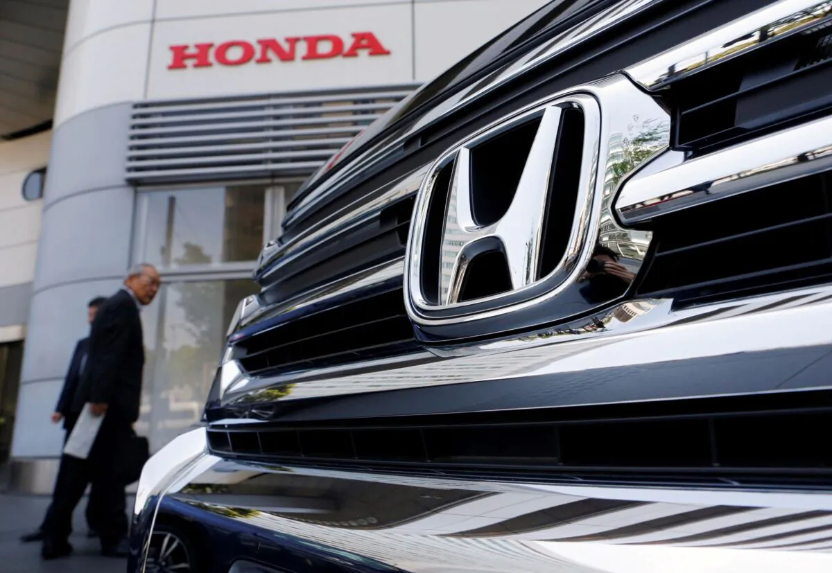 Visitors look at a Honda Motor Co. car displayed outside the company showroom in Tokyo, Japan, on April 26, 2013. (Yuya Shino/Reuters)