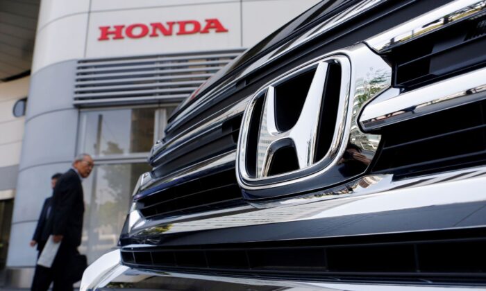 Visitors look at a Honda Motor Co. car displayed outside the company showroom in Tokyo, Japan, on April 26, 2013. (Yuya Shino/Reuters)