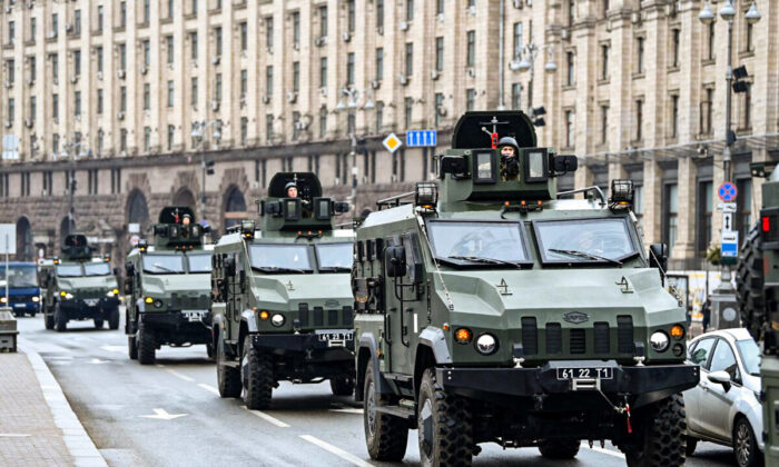 Ukrainian military vehicles move past Independence square in central Kyiv, Ukraine, on Feb. 24, 2022.  (Daniel Leal/AFP via Getty Images)