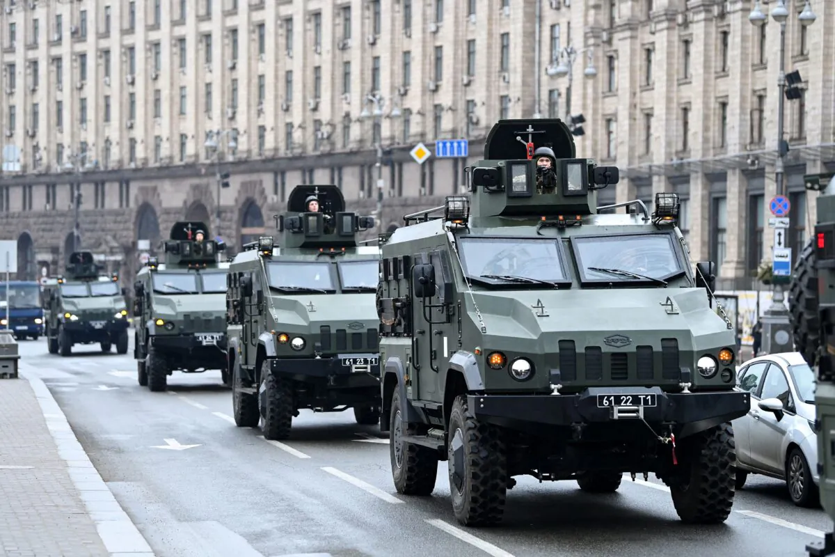 Ukrainian military vehicles move past Independence square in central Kyiv on Feb. 24, 2022. Air raid sirens rang out in downtown Kyiv today as cities across Ukraine were hit with what Ukrainian officials said were Russian missile strikes and artillery. (Daniel Leal/AFP via Getty Images)