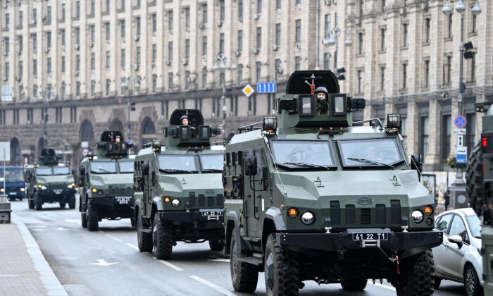Ukrainian military vehicles move past Independence square in central Kyiv on Feb. 24, 2022. Air raid sirens rang out in downtown Kyiv today as cities across Ukraine were hit with what Ukrainian officials said were Russian missile strikes and artillery. (Daniel Leal/AFP via Getty Images)