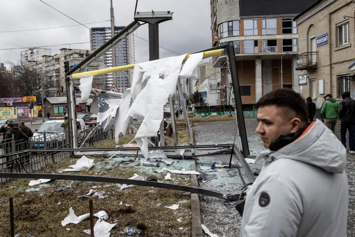 People stand around a damaged structure said to have been caused by a rocket in Kyiv, Ukraine, on Feb. 24, 2022. (Chris McGrath/Getty Images)