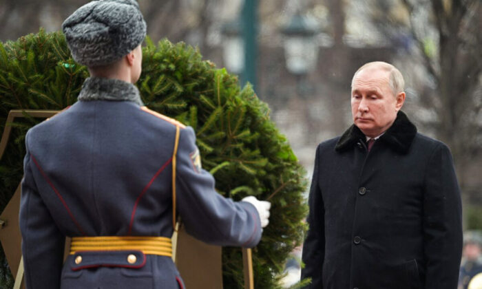 Russian President Vladimir Putin takes part in a wreath laying ceremony at the Tomb of the Unknown Soldier by the Kremlin Wall on the Defender of the Fatherland Day in Moscow, Russia, on Feb. 23, 2022. (Sputnik/Aleksey Nikolskyi/Kremlin via Reuters)
