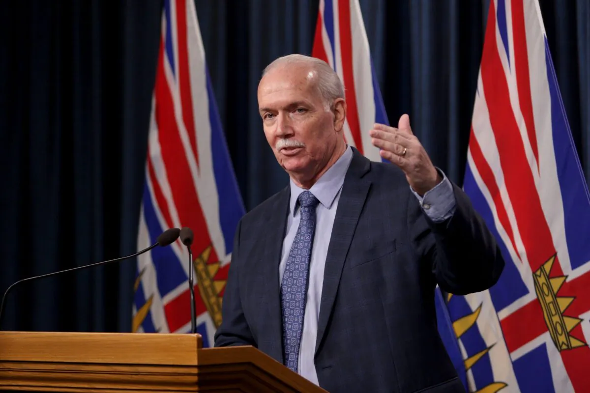 B.C. Premier John Horgan answers questions from the media following the speech from the throne in Victoria on Feb. 8, 2022. (The Canadian Press/Chad Hipolito)