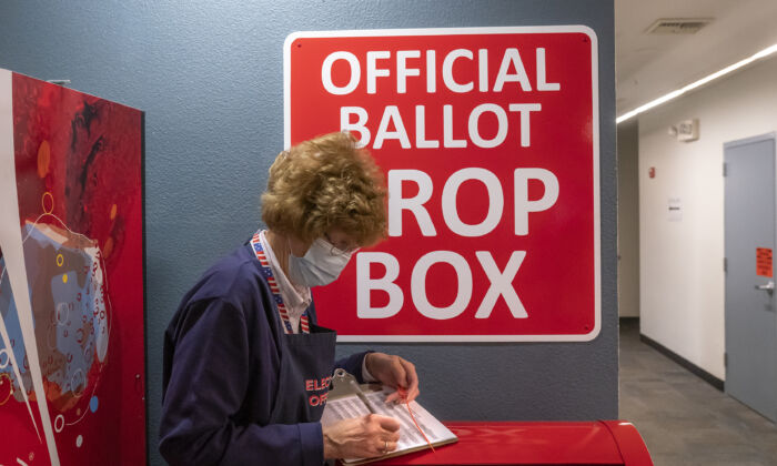 An election worker makes a record of a ballot pickup on Nov. 3, 2020 in Vancouver, Washington. (Nathan Howard/Getty Images)