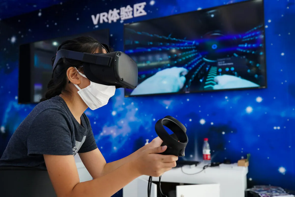 An visit wear protective face masks to against the spread of the coronavirus as she experience VR glasses during the 2020 China International Fair for Trade in Services (CIFTIS) at Beijing Olympic Park, in Beijing, China, on Sept. 6, 2020. (Lintao Zhang/Getty Images)