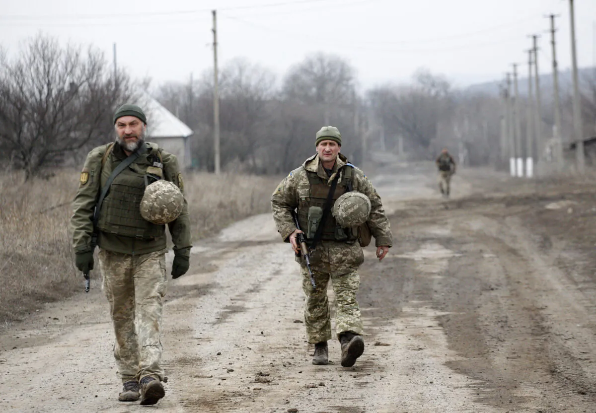 Ukrainian servicemen patrol in the settlement of Troitske in the Lugansk region near the front line with Russia-backed separatists on Feb. 22, 2022. (Anatolii Stepanov/AFP via Getty Images)