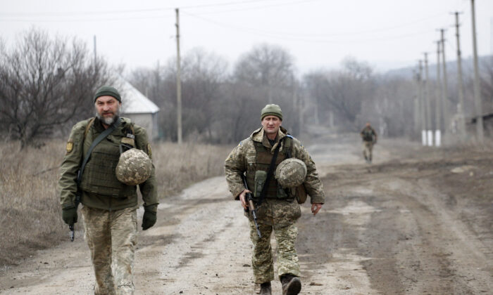 Ukrainian servicemen patrol in the settlement of Troitske in the Lugansk region near the front line with Russia-backed separatists on Feb. 22, 2022. (Anatolii Stepanov/AFP via Getty Images)