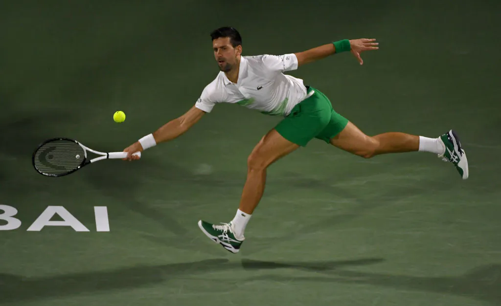 Novak Djokovic of Serbia returns the ball in the second round match against Karen Khachanov of Russia during day 10 of the Dubai Duty Free Tennis in Dubai, United Arab Emirates on February 23, 2022. (Photo by Martin Dokoupil/Getty Images)