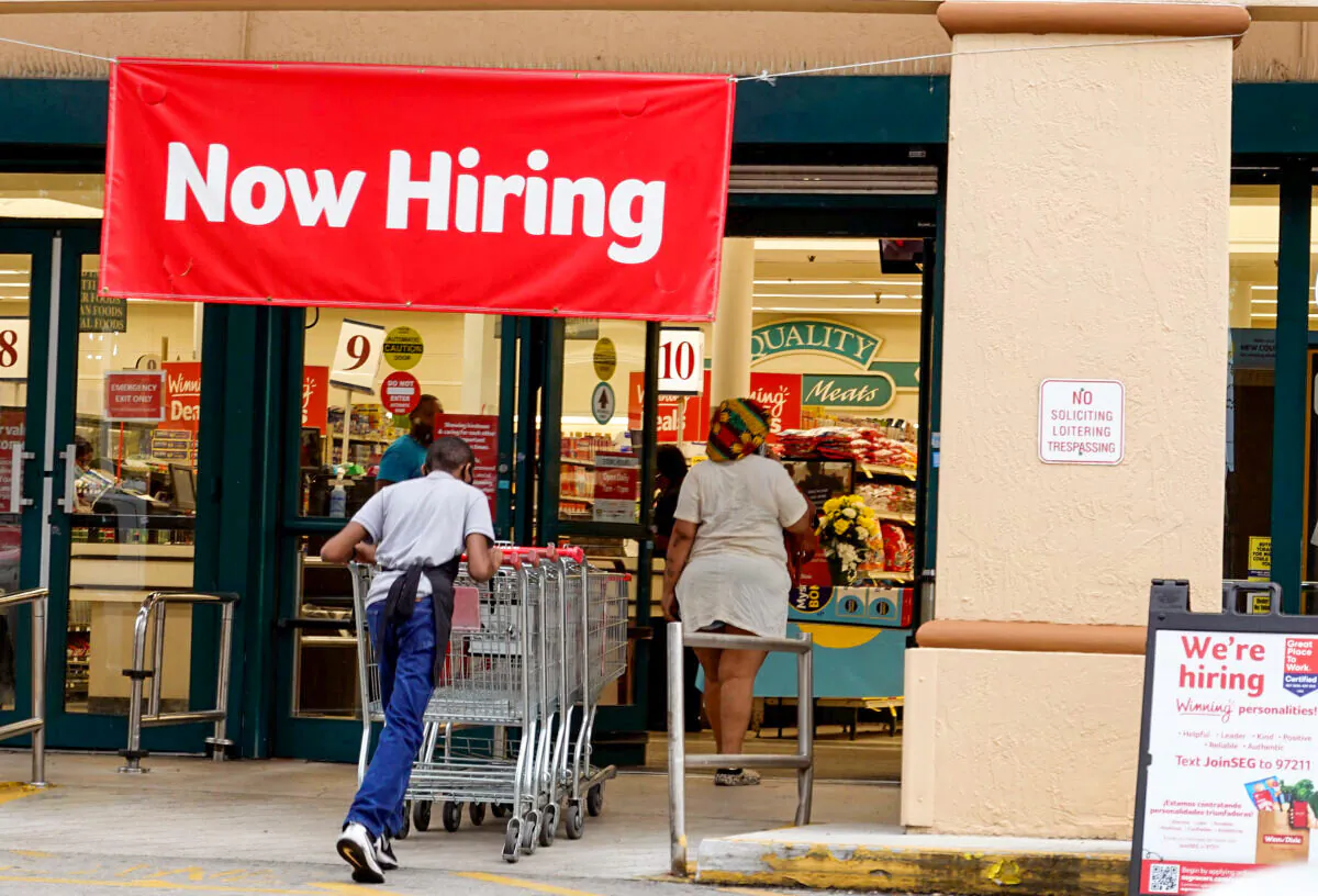 A 'Now Hiring' sign hangs near the entrance to a Winn-Dixie Supermarket in Hallandale, Fla., on Sept. 21, 2021. (Joe Raedle/Getty Images)
