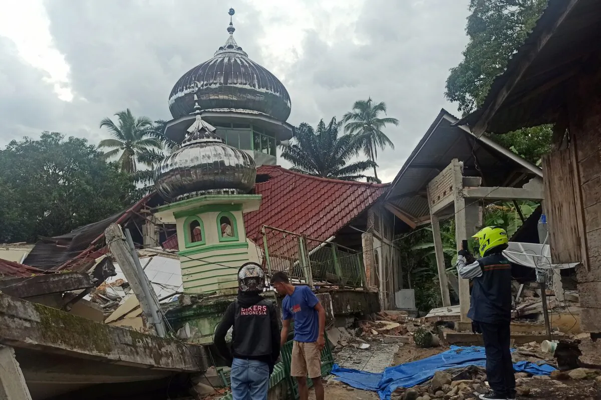 People inspect a damaged mosque following an earthquake in Pasaman, West Sumatra, Indonesia, on Feb. 25, 2022. (Marsulai/AP Photo)