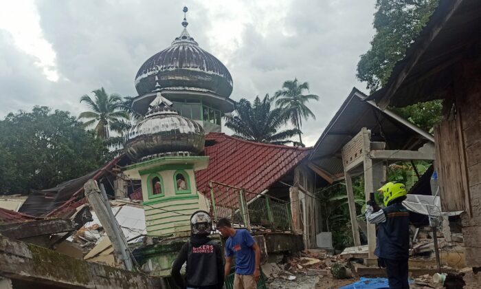 People inspect a damaged mosque following an earthquake in Pasaman, West Sumatra, Indonesia, on Feb. 25, 2022. (Marsulai/AP Photo)