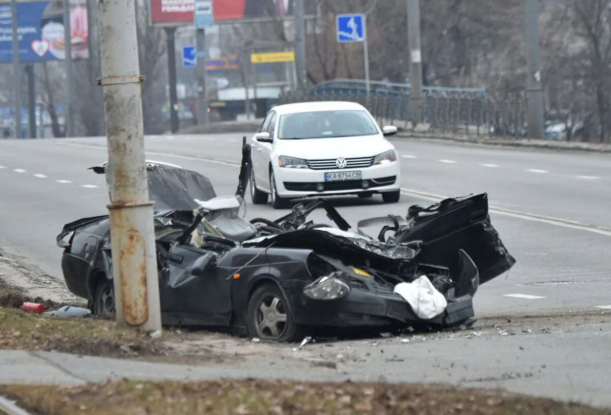 The wreckage of a vehicle lies on a road after a skirmish between Ukrainian forces and a Russian raiding party in the Ukrainian capital of Kyiv on Feb. 25, 2022. (Sergei Supinsky/AFP via Getty Images)