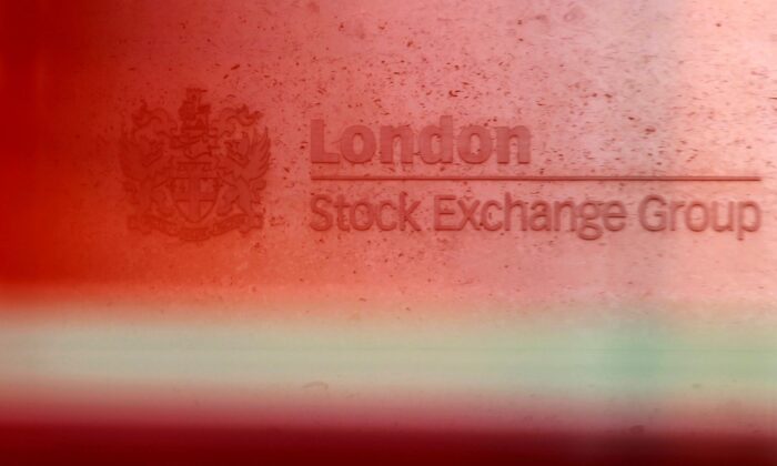 A red London bus passes the Stock Exchange in London, Britain, on Feb. 9, 2011. (Luke MacGregor/Reuters)
