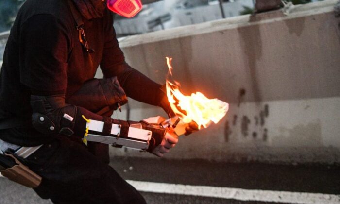 A file photo of a man holding a lit Molotov cocktail bomb (Anthony Wallace/AFP/Getty Images)