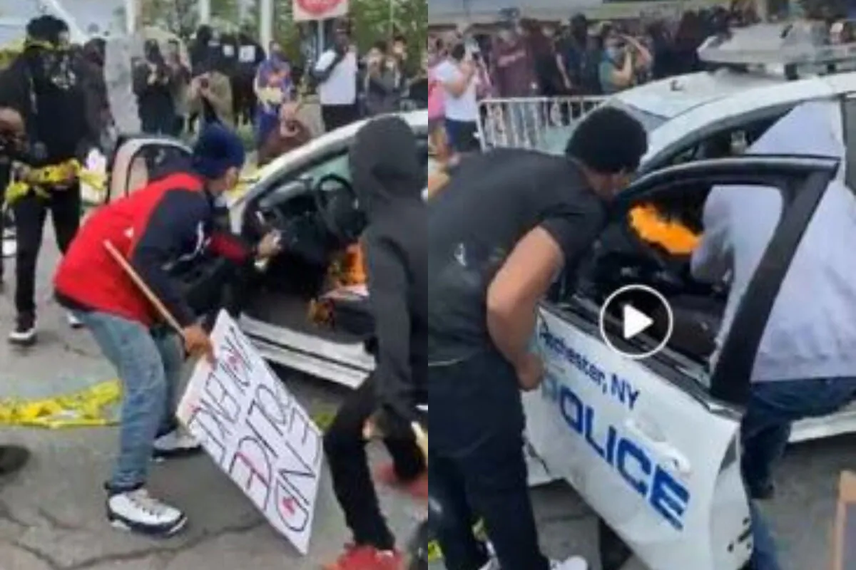 Miguel Ramos, wearing a red jacket, helps set a fire to a Rochester Police Department vehicle on May 30, 2020. (ATF)