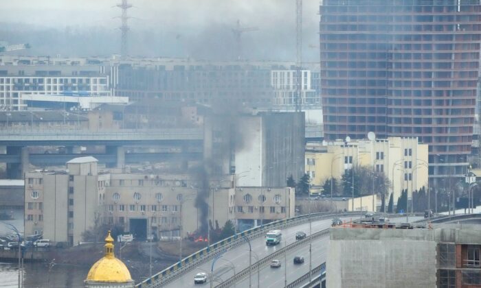 Smoke and flame rise near a military building after an apparent Russian strike in Kyiv, Ukraine, on Feb. 24, 2022. (Efrem Lukatsky/AP Photo)