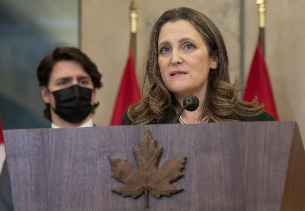 Prime Minister Justin Trudeau looks on as Finance Minister Chrystia Freeland announces that the Emergencies Act will be invoked to deal with the convoy protests, in Ottawa on Feb. 14, 2022. (THE CANADIAN PRESS/Adrian Wyld)