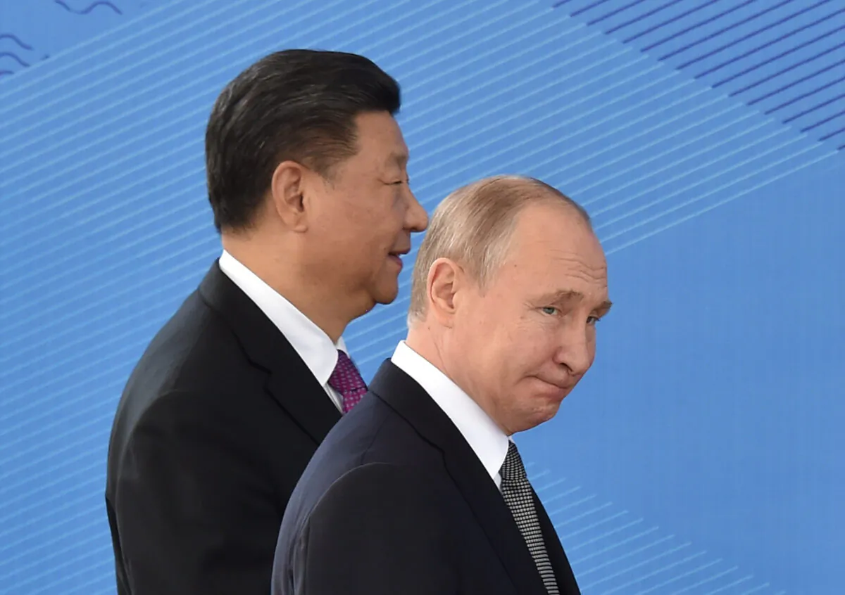 Russian President Vladimir Putin and Chinese leader Xi Jinping walk as they attend a meeting of the Shanghai Cooperation Organisation Council of Heads of State in Bishkek on June 14, 2019. (Vyacheslav Oseledko/AFP via Getty Images)