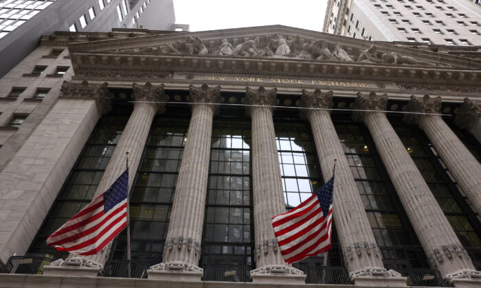 Flags are seen outside the New York Stock Exchange (NYSE) in New York City, where markets roiled after Russia continues to attack Ukraine, in New York, on Feb. 24, 2022. (Caitlin Ochs/Reuters)