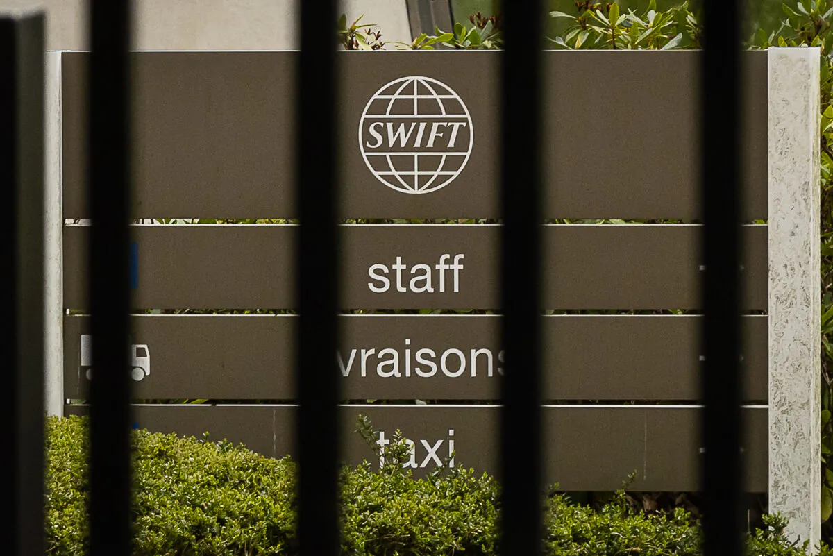 A sign outside the headquarters of the Society for Worldwide Interbank Financial Telecommunication, or SWIFT, in Terhulpen, near Brussels, Belgium, on Feb. 25, 2022. (James Arthur Gekiere/Belga Mag/AFP via Getty Images)