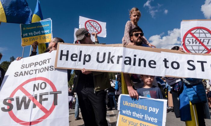 Ukrainian residents of Cyprus demonstrate against the Russian invasion of Ukraine, in Nicosia, Cyprus, on Feb. 26, 2022. (Iakovos Hatzistavrou/AFP via Getty Images)