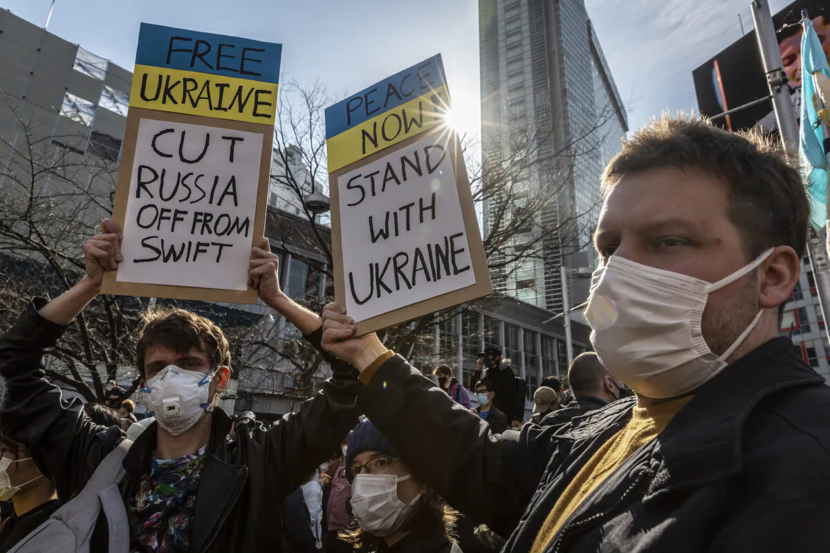 Protesters hold placards during a protest against Russia's attack on Ukraine, in Tokyo, Japan, on Feb. 26, 2022. (Yuichi Yamazaki/Getty Images)