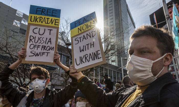 Protesters hold placards during a protest against Russia's attack on Ukraine, in Tokyo, Japan, on Feb. 26, 2022. (Yuichi Yamazaki/Getty Images)
