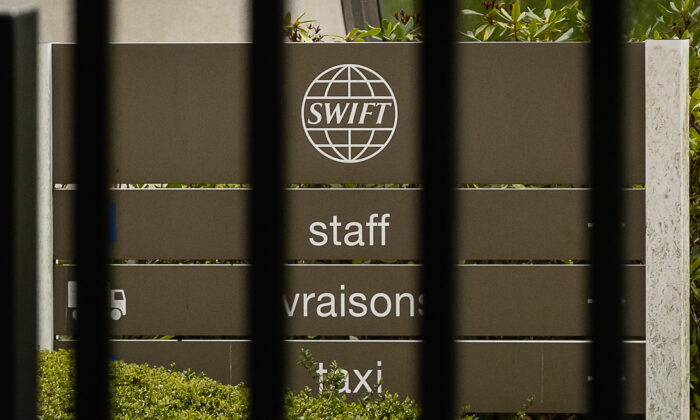 A sign outside the headquarters of the World Bank Interbank Financial Communications Association (SWIFT) in Telfurpen, near Brussels, Belgium, on February 25, 2022.  (Via James Arthur Gequier / Bergamag / AFP, Getty Images)