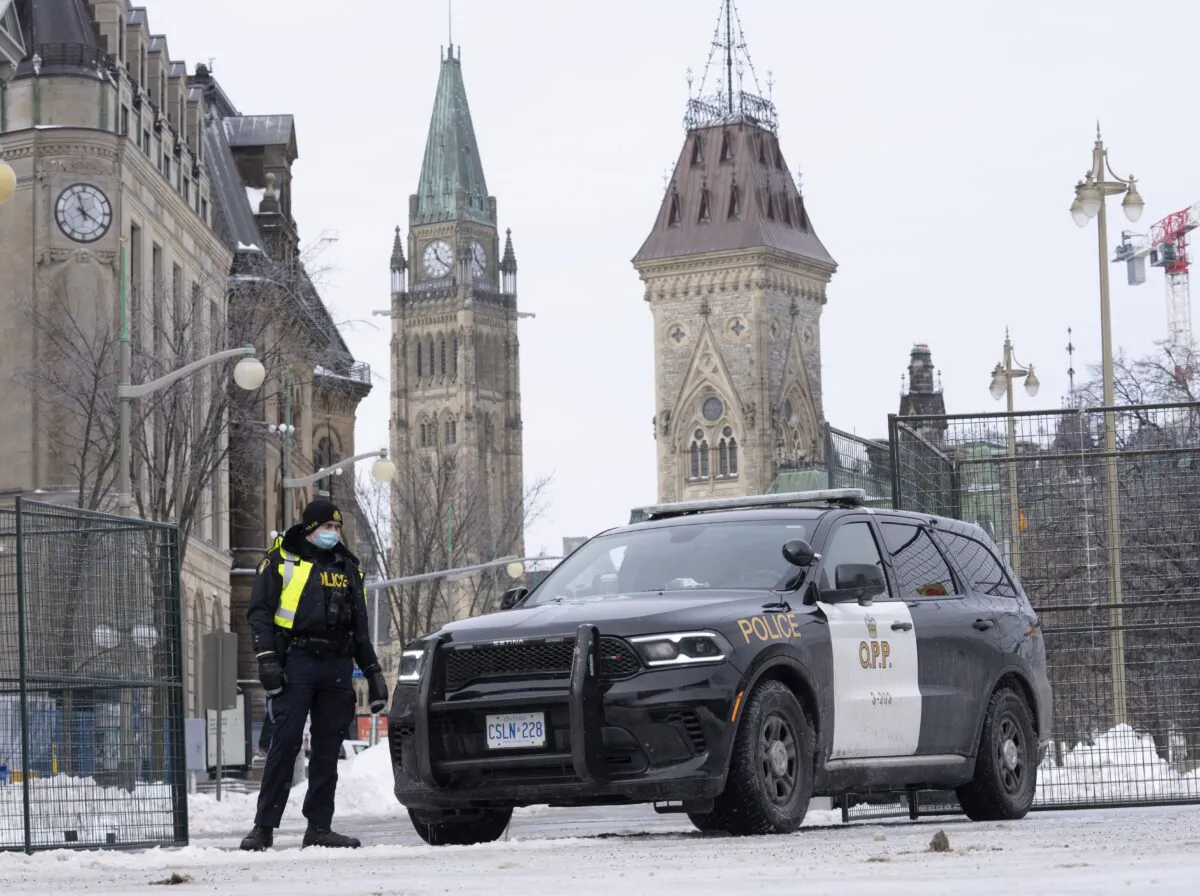 A police officer mans a checkpoint near Parliament Hill in Ottawa on Feb. 23, 2022. (The Canadian Press/Adrian Wyld)