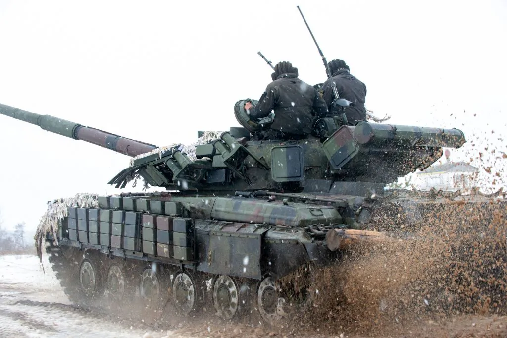 Ukrainian Military Forces servicemen of the 92nd mechanized brigade use tanks, self-propelled guns and other armored vehicles to conduct live-fire exercises near the town of Chuguev, in Kharkiv region, Ukraine, on Feb. 10, 2022. (Sergey Bobok/AFP via Getty Images)