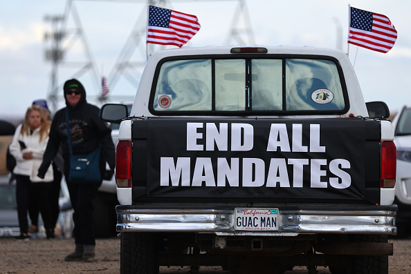 ADELANTO, CALIFORNIA - FEBRUARY 23: A sign reads 'End All Mandates' as supporters and truckers gather before a ‘People’s Convoy’ departs for Washington, DC to protest COVID-19 mandates on February 23, 2022 in Adelanto, California. The protestors are calling for a full re-opening of the country and are scheduled to arrive in Washington, DC, on March 5. (Photo by Mario Tama/Getty Images)