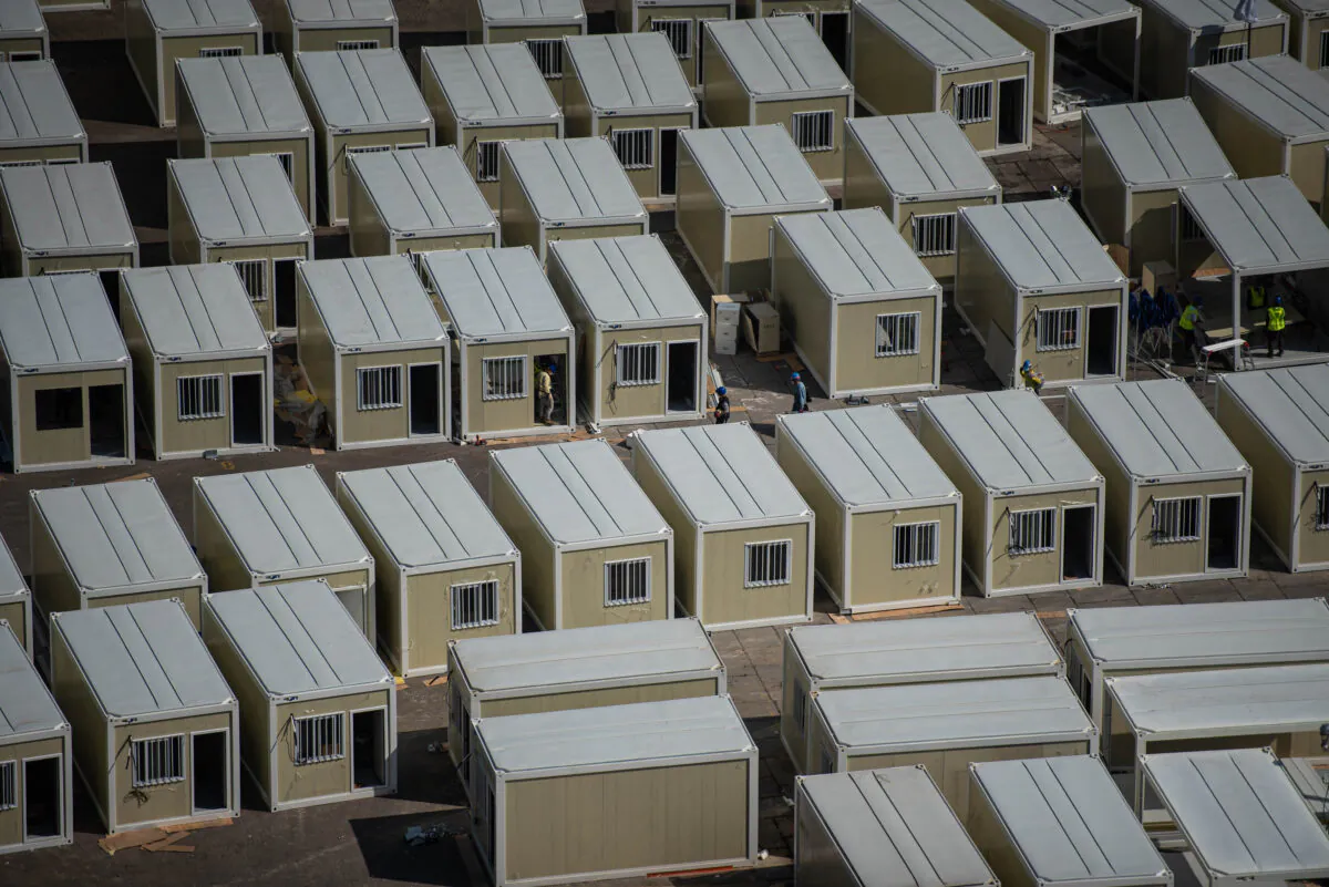 Workers at the construction site of a COVID-19 isolation facility in Tsing Yi in Hong Kong on Feb. 25, 2022. (Louise Delmotte/Getty Images)