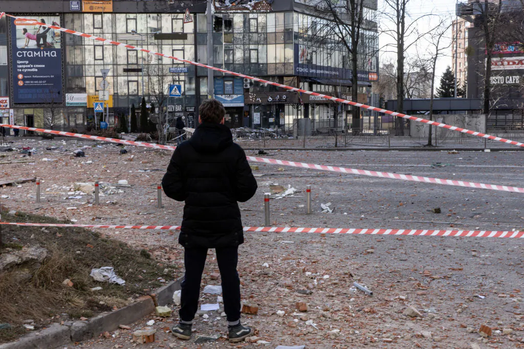 A man looks at damage from a residential apartment building that was hit by a missile in Kyiv, Ukraine, on Feb. 26, 2022. (Chris McGrath/Getty Images)