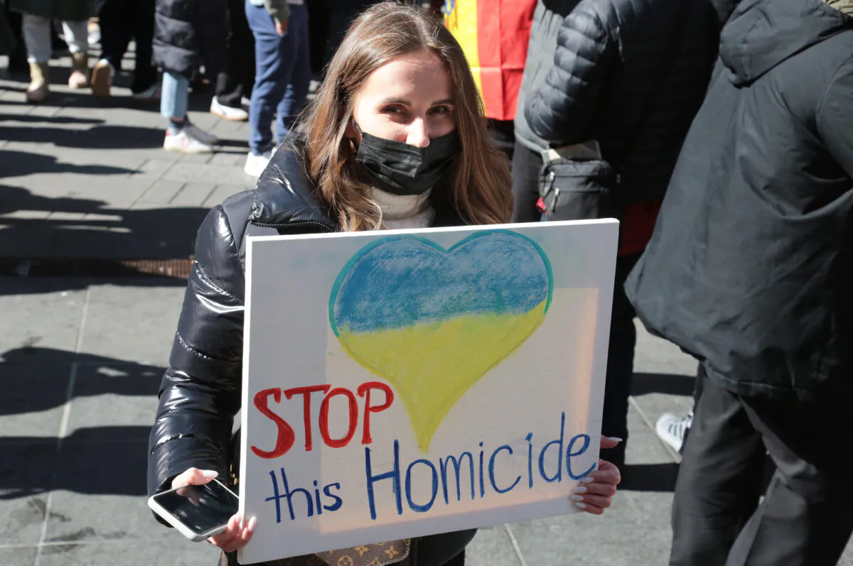 A woman calls for peace at a rally in Times Square on Feb. 26, 2022. (Richard Moore/The Epoch Times)