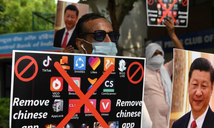 Members of the Working Journalist of India (WJI) hold placards urging citizens to remove Chinese apps and stop using Chinese products during a demonstration against the Chinese newspaper Global Times, in New Delhi, on June 30, 2020. (Prakash Singh/AFP via Getty Images)