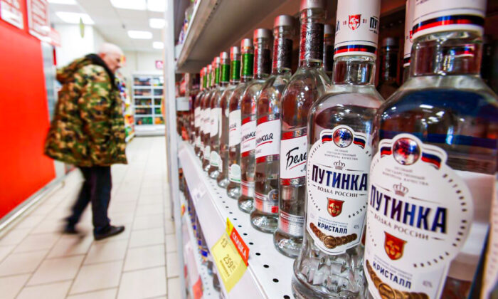 A customer walks past shelves with bottles of vodka in a supermarket amid the COVID-19 pandemic in Moscow, Russia, on April 8, 2020. (Maxim Shemetov/Reurers)