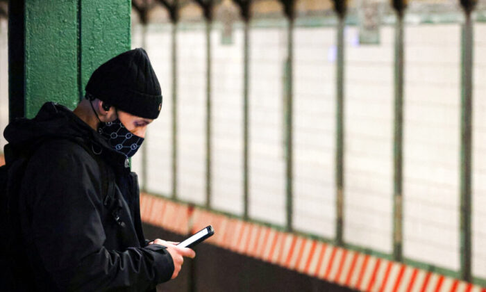 A person uses a smartphone on a subway platform in Manhattan, New York City on Feb. 11, 2022. (Andrew Kelly/Reuters)