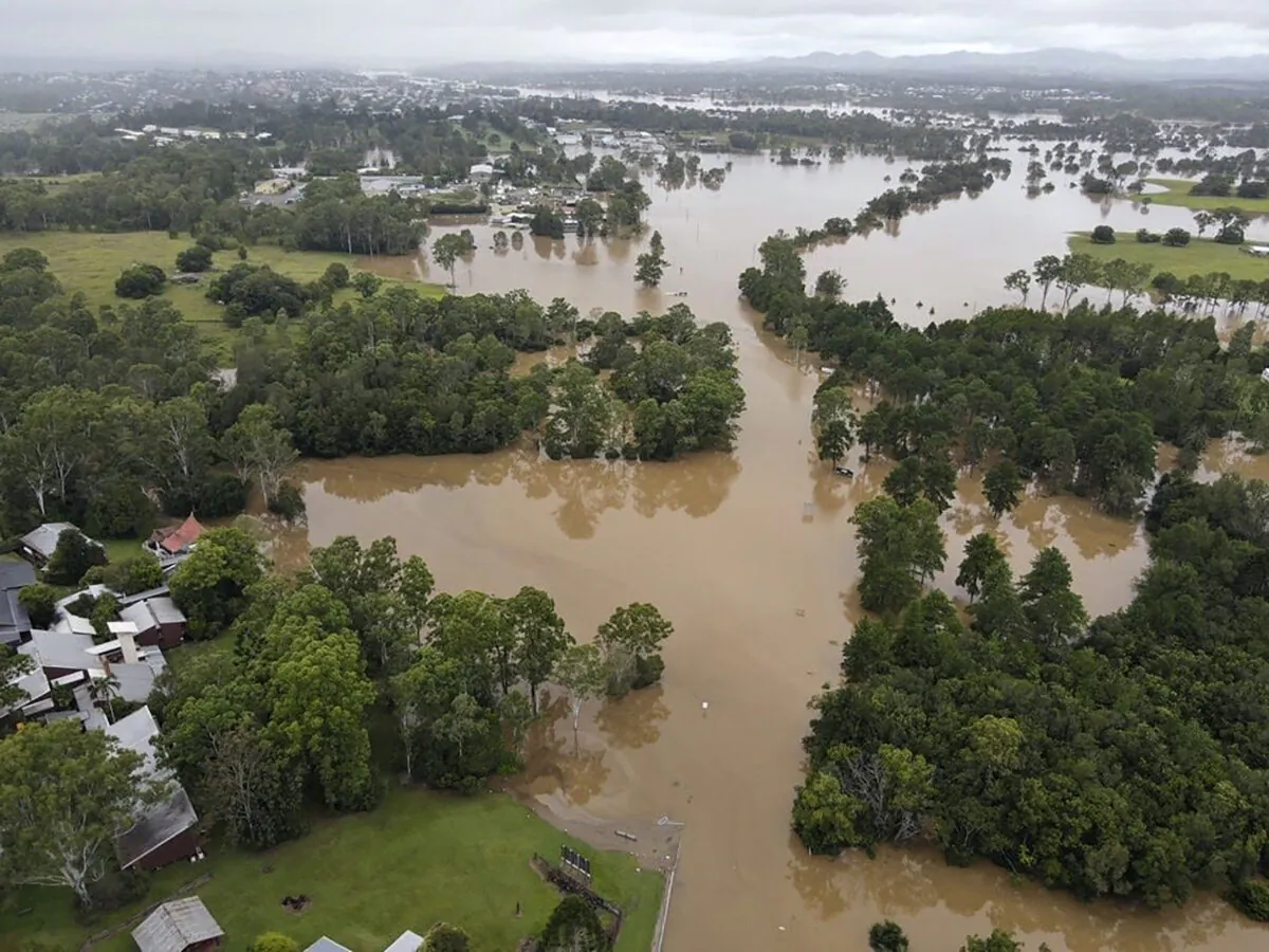 In this photo provided by the Queensland Fire and Emergency Services, water floods land and buildings near Gympie, north of Brisbane, Australia Sunday, Feb. 27, 2022. Heavy rain is bringing record flooding to some east coast areas and claimed seven lives while the flooding in Brisbane, a population of 2.6 million, and its surrounds is the worst since 2011 when the city was inundated by what was described as a once-in-a-century event. (Queensland Fire and Emergency Services via AP)