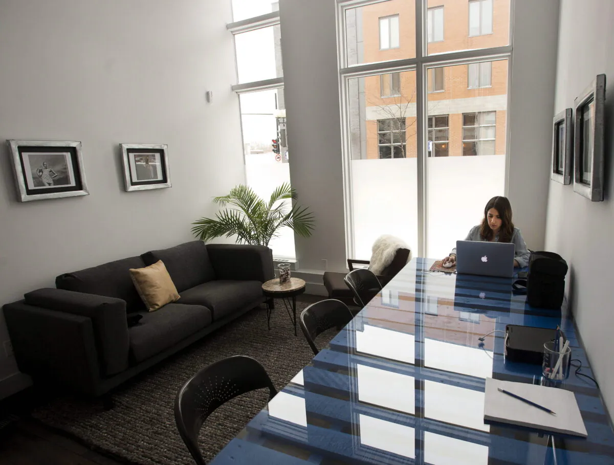 A woman is seen working in an office space in Montreal on Feb. 9, 2015. (The Canadian PressS/Ryan Remiorz)