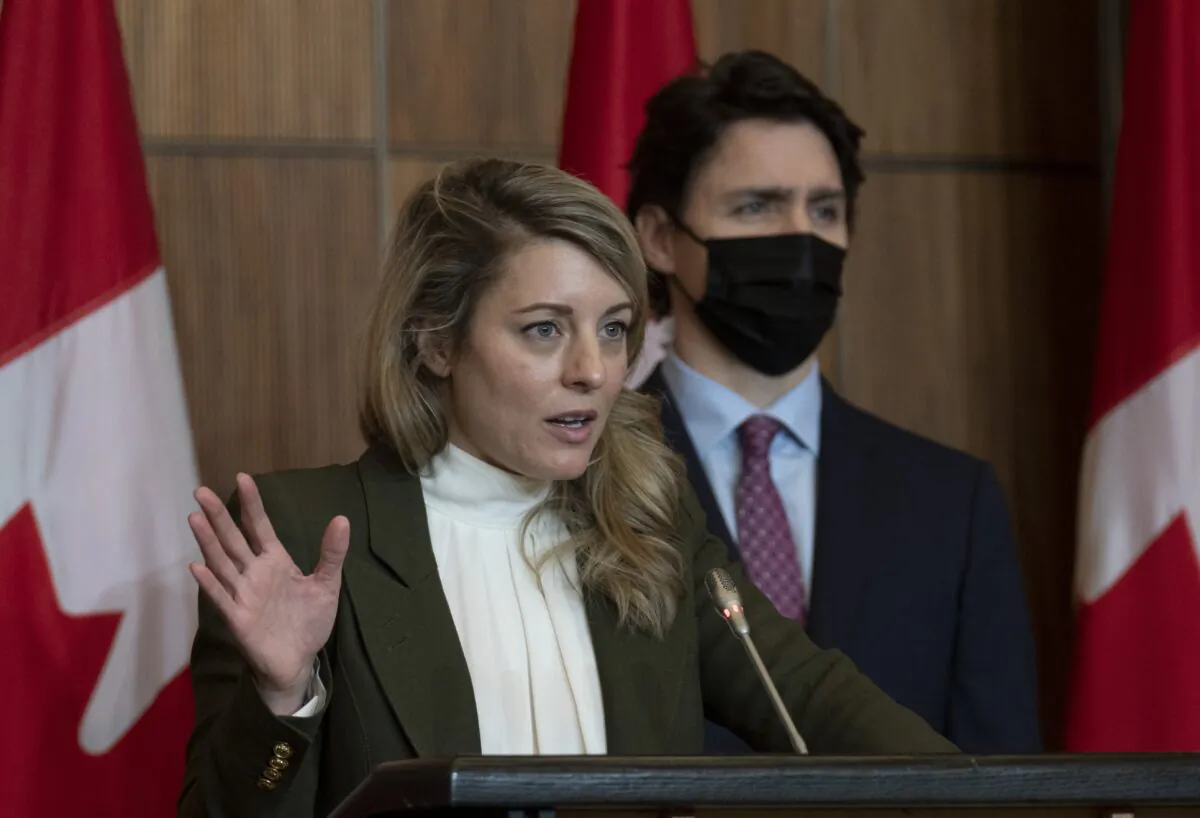 Prime Minister Justin Trudeau looks on as Foreign Affairs Minister Melanie Joly speaks during a news conference, in Ottawa on Feb. 25, 2022. (Adrian Wyld/The Canadian Press)