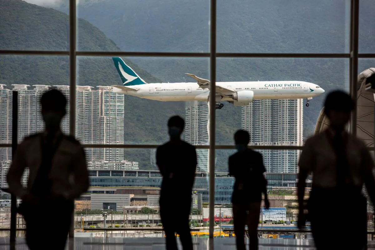 A Cathay Pacific aircraft comes in to land at Hong Kong International Airport on Aug. 11, 2021. (Isaac Lawrence/AFP via Getty Images)