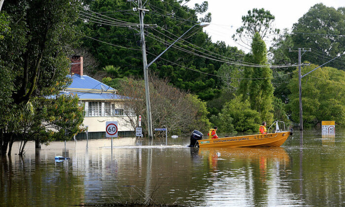 State Emergency Service staff patrol a flooded Brunswick Street in Lismore on May 22, 2009. (EDDIE SAFARIK/AFP via Getty Images)
